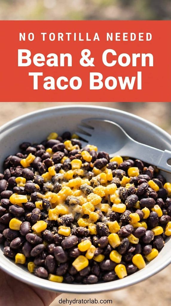 A camping bowl of black beans and corn with melted cheese powder on a trail